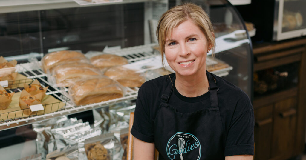 Goodies Gluten-Free Bakery owner Brooke stands in front of fresh baked goods